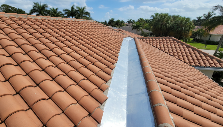 Overhead view of repaired roof tiles beside a clean roof valley