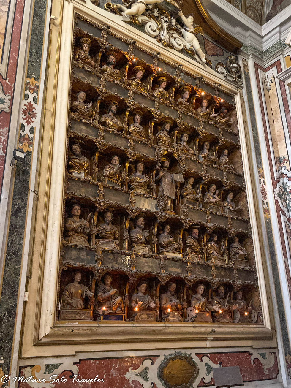 five high and seven wide, these little statues of all different appearances look like a heavenly choir about to sing. They are mounted on the left wall of an chapel within the Gesù Nuovo Naples Italy