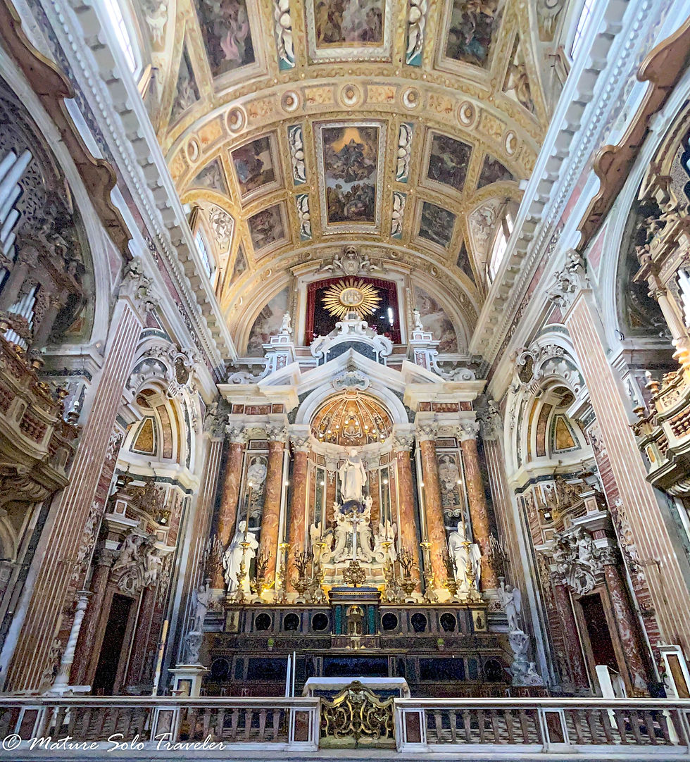 the high altar of the church has a statue of the Virgin Mary behind it. On either side are statues of saints. There is beauty everwhere. The ceiling has painted frescos of biblical scenes, the walls are decorated with many religious icons.