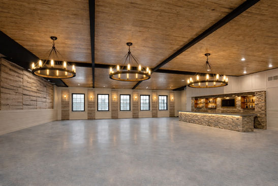 STONE HILL RECEPTION VENUE FARMHOUSE CHANDELIERS CUSTOM BAR WARM SPACIOUS
