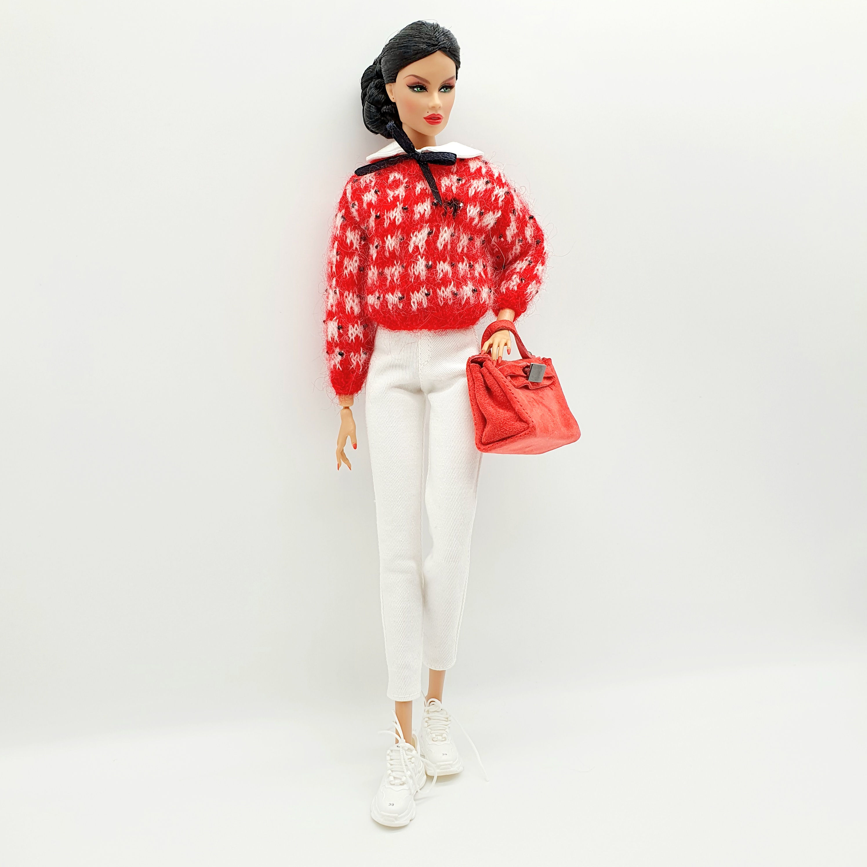 Doll in red sweater, white pants, and handbag
