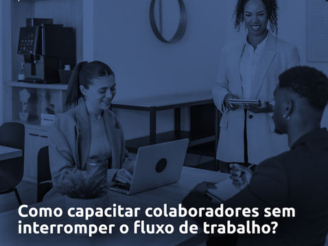 Três pessoas em um ambiente de trabalho, duas sentadas conversando enquanto utilizam notebook e celular, e uma em pé segurando um tablet. 