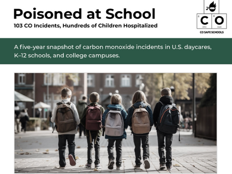 Five elementary-aged students with backpacks on walking into their school