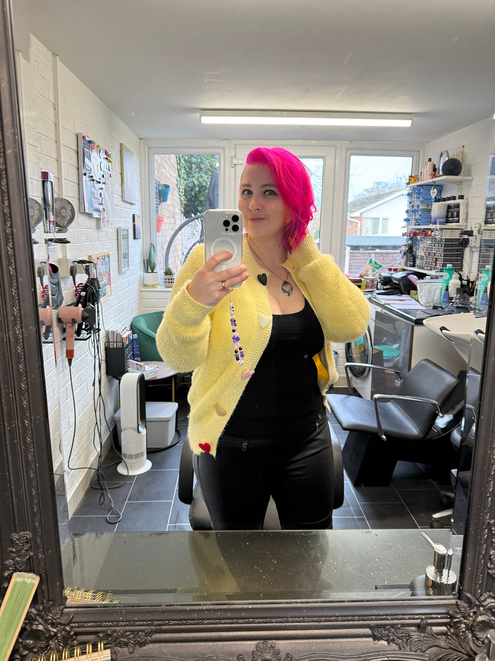 Menopausal hairdresser in Bright room with salon equipment visible.