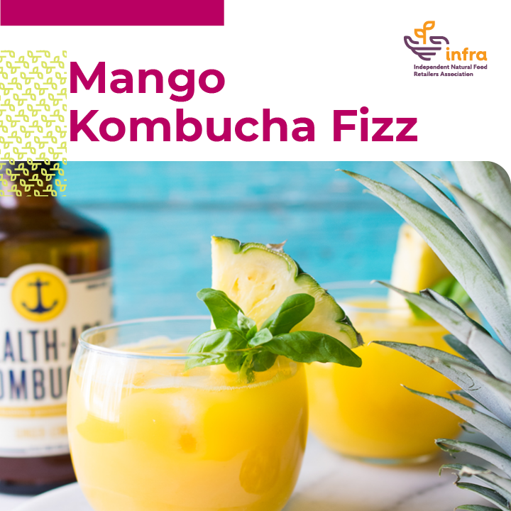 a yellow fizzy drink with a pineapple slice and basil as garnish