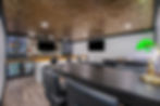 Game room with bar, TVs, and long table