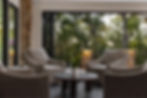 Cozy patio furniture overlooks a wooded scene