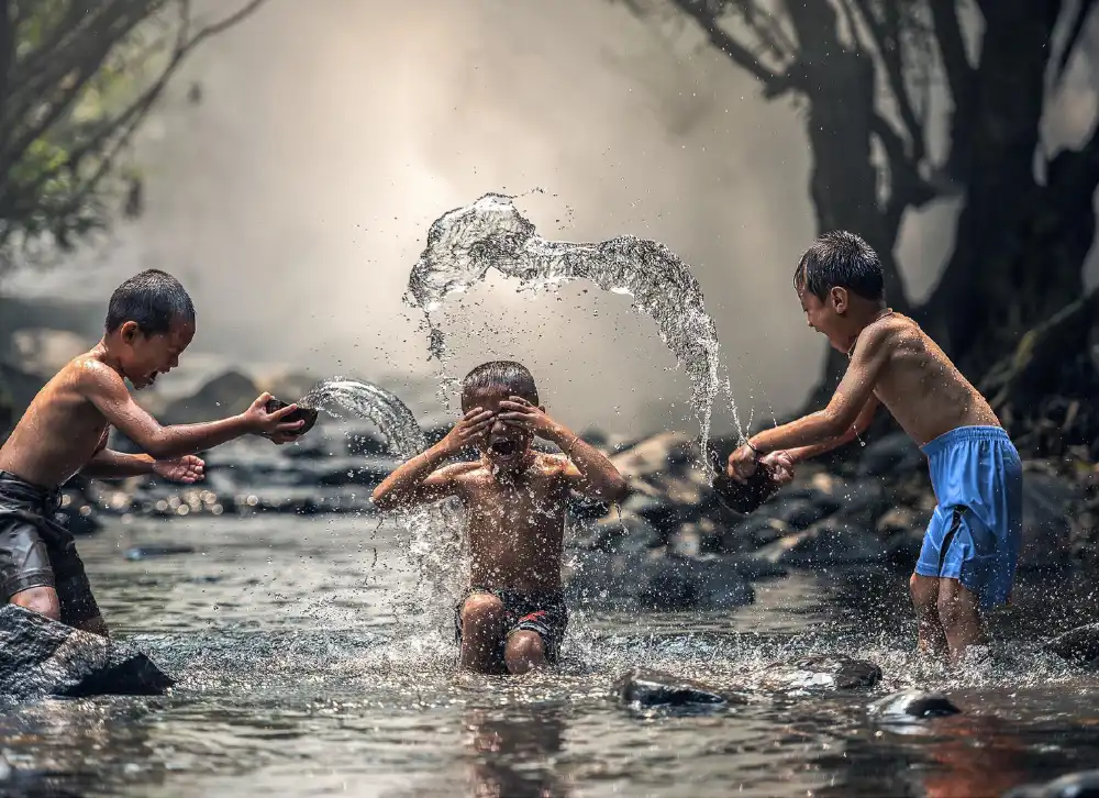 Boy-Splashing-River.webp