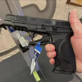 Person holding a Smith & Wesson M&P pistol at SHOT Show