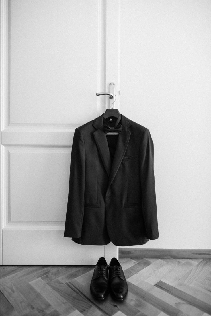 Classic black tuxedo and shoes laid out before the groom gets dressed_ A clean, minimalist