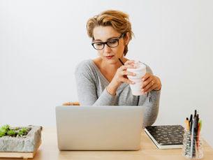 Woman attending an online outpatient alcohol rehab session from home