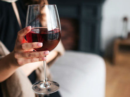 Person reflecting quietly on their drinking and considering moderation