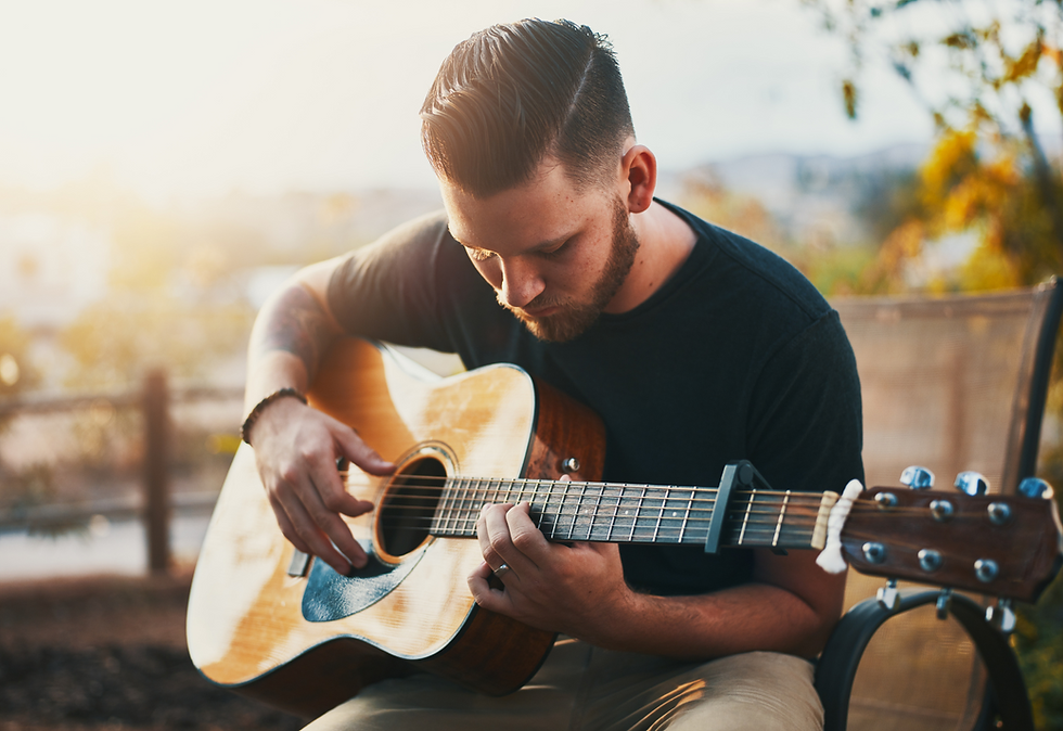 A dad playing guitar, enjoying his passion while balancing fatherhood.