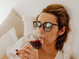Professional woman sitting at home reflecting on their relationship with alcohol after work