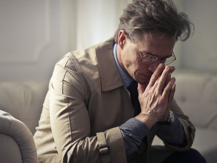 High-functioning adult quietly reflecting on their drinking habits