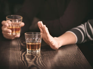 Person reflecting on when to quit drinking