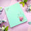 Thumbnail: Notepad with milk tea and cherry blossoms on pastel blue background, 5.5 x 4.25 inch pad