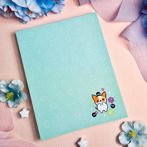 Notepad with kawaii dog, konpeito candy, and sprite creatures on blue background, 5.5 x 4.25 inch pad