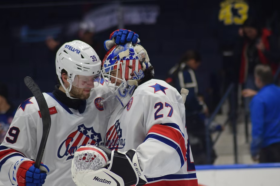 Devon Levi and Zac Jones celebrating a win against the Syracuse Crunch on January 14, 2026, Photo credit: Mateo Ortiz / 89.1 The Point