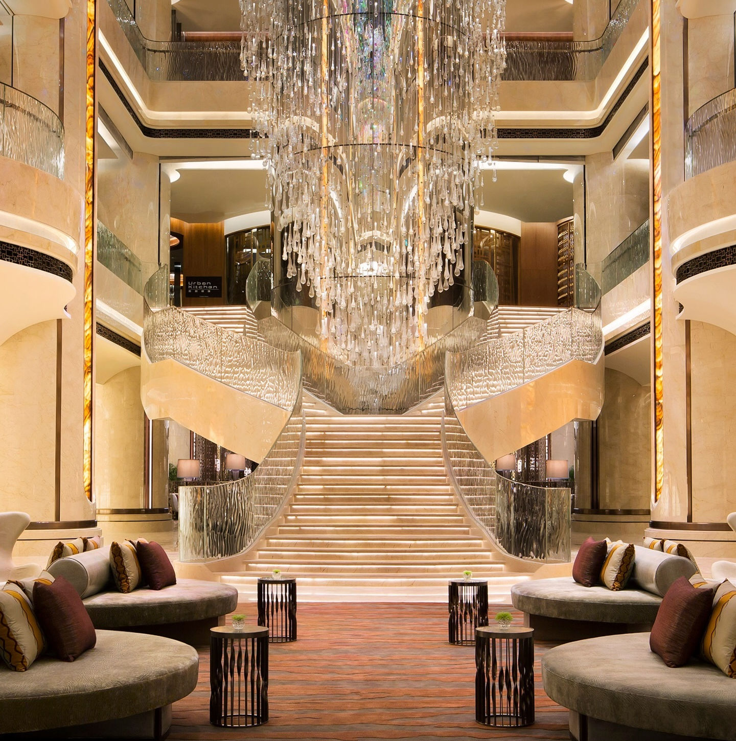 Elegant hotel lobby with a large chandelier and comfortable seating areas.
