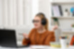 A woman on a consultation call using her laptop, representing tailored Montessori guidance for preschools, including space design, material recommendations, curriculum reviews, and parent engagement strategies.