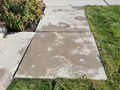Front concrete walkway slabs beside a lawn at a home in Spanish Fork