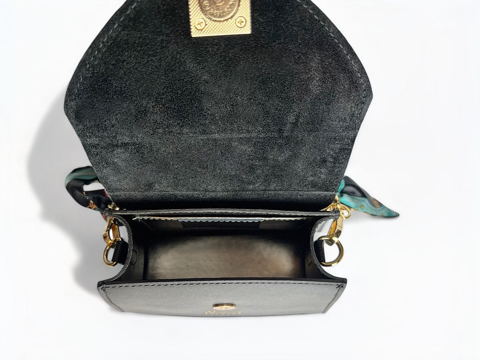Thumbnail: Interior of little black leather bag with suede lining and interior pocket