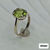 Thumbnail: Oval peridot secured by four sculpted prongs on polished sterling silver band