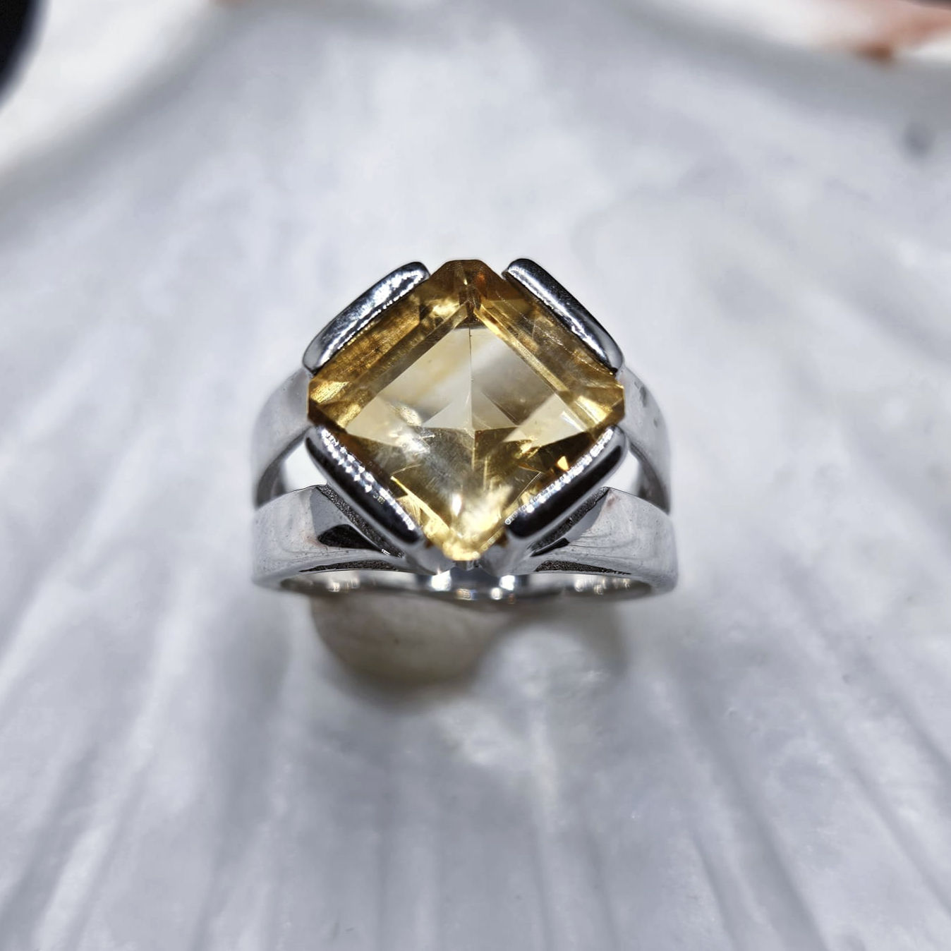 Princess-cut citrine in claw setting on a tapered split silver band