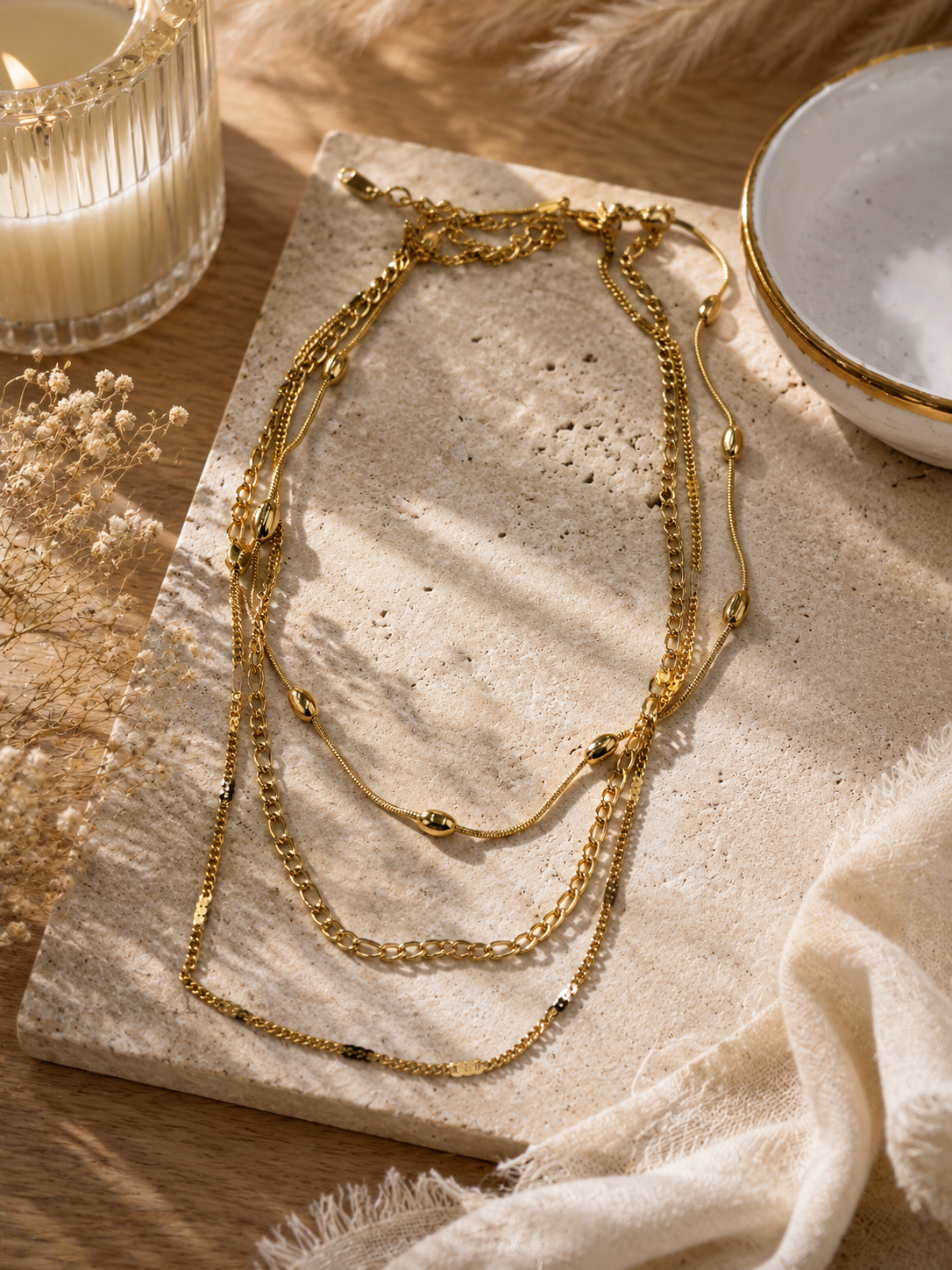 Gold stamped curb, figaro and oval bead layered necklace 