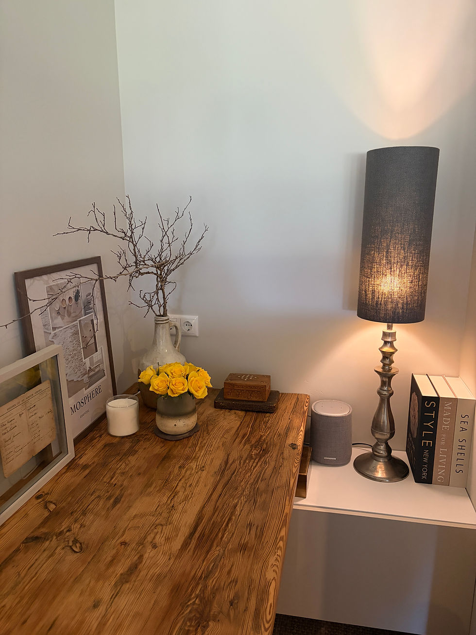 Wooden desk with fresh yellow roses and styling items