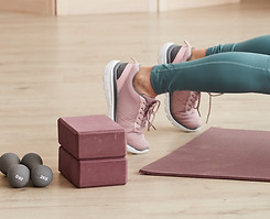 mature-woman-exercising-floor-front-lapt