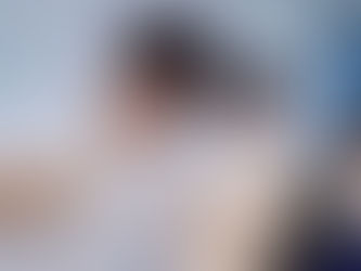 A male student in white uniform practices a medical procedure on a mannequin’s face, watched by two others in a clinical training room.