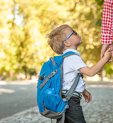 Parent taking child to school. Pupil of