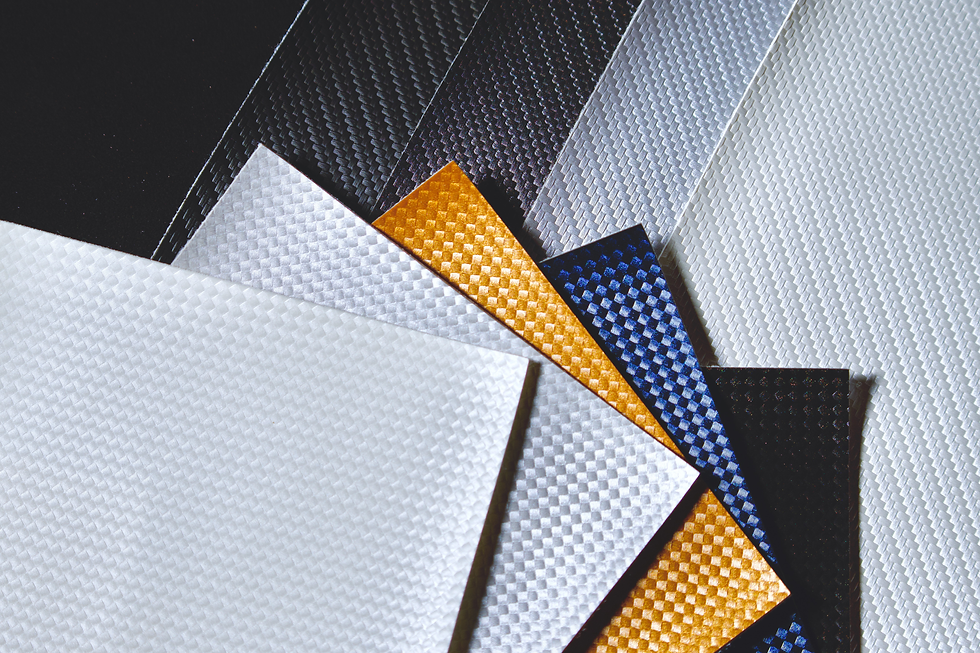 Stack of marine vinyl options. Carbon fiber and basketweave print.