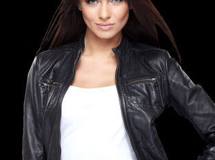 Woman wearing a fitted black leather jacket, representing professional leather cleaning and alteration services.