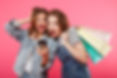 shocked-two-women-friends-holding-shoppi