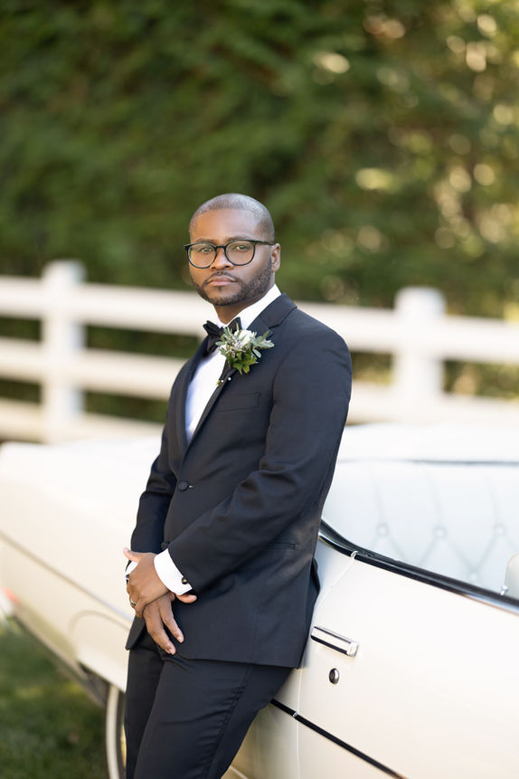 Groom posing for a wedding portrait at Five Bridge Inn before the ceremony.