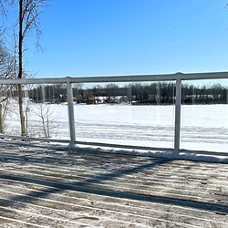 a cleared off deck in the winter overlooking the lake