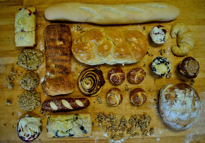 a variety of breads laid out on the cutting board
