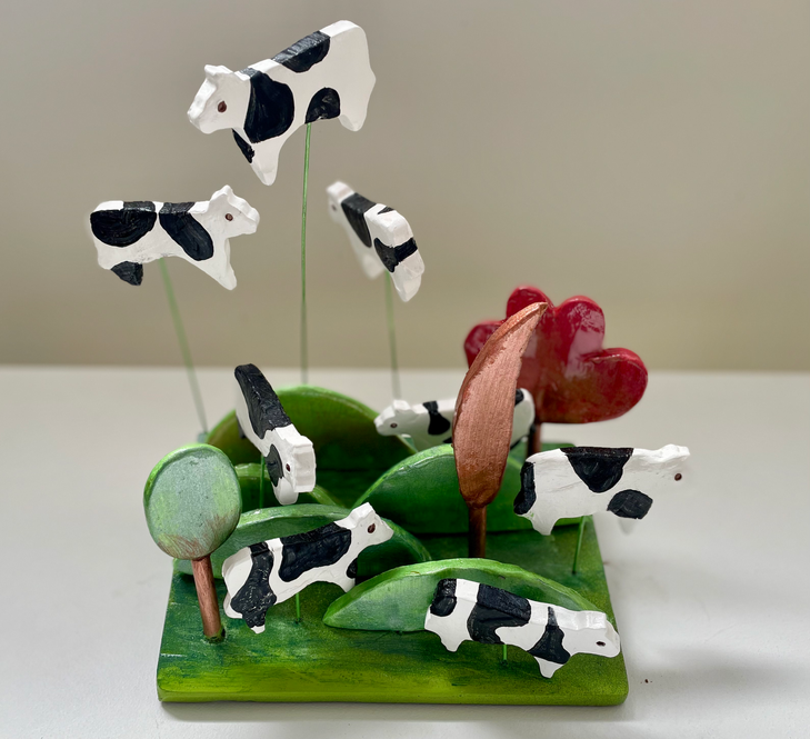 ceramic cows in a field