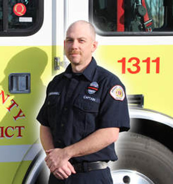 Firefither Casey McDonnell in front of Engine 1311
