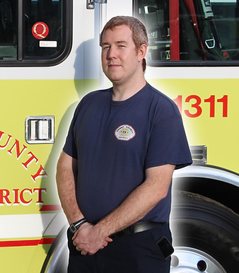 Firefighter Nick Weitzel in front of Engine 1311