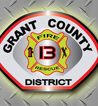 District 13 patch on diamond plate with yellow glow around it.