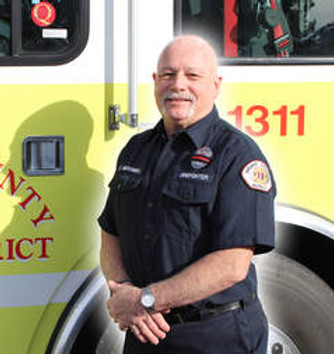 Firefighter Jim McDonnell in front of engine 1311.
