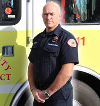 Firefighter Andy Rolfe in front of engine 1311