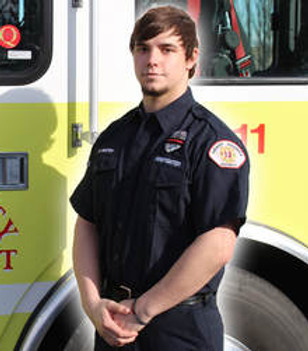 Firefighter Hayden Heston in front of Engine 1311