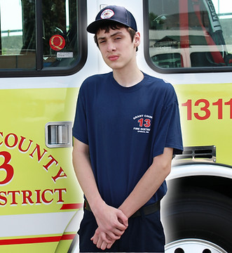 Firefighter Peyton Weitzel in front of Engine 1311