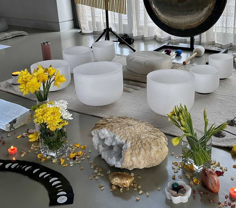 Close-up view of shimmering crystals and sound bowls arranged for a healing session