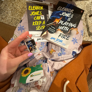 The photo depicts two books in the frame - "Eleanor Jones Can't Keep a Secret" and "Eleanor Jones is Playing With Fire", both by Amy Doak.